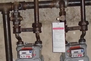 Gas meters with pipes and a tag.