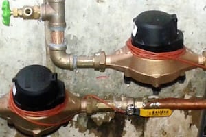 Two water meters with connected pipes.