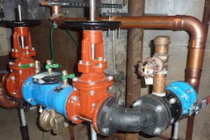 Pipes and valves in industrial setting.